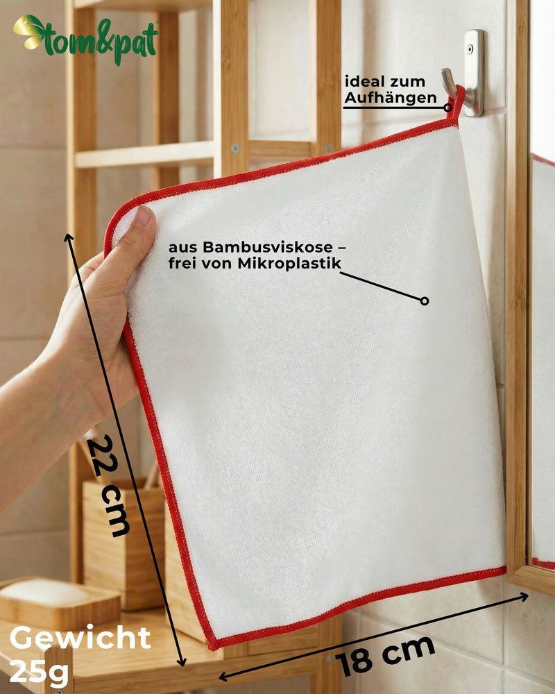 Infografik: Bambus-Putztuch mit roter Kante, Maße 22 x 18 cm, hängt an der Aufhängeschlaufe am Haken im Bad